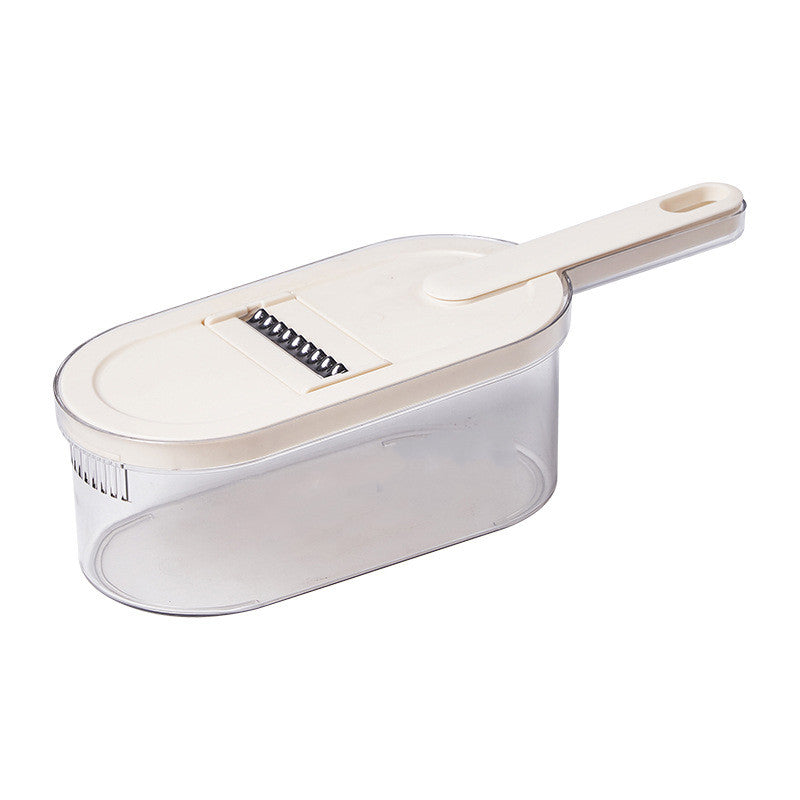 Manual vegetable slicer with food collection basket and cleaning brush